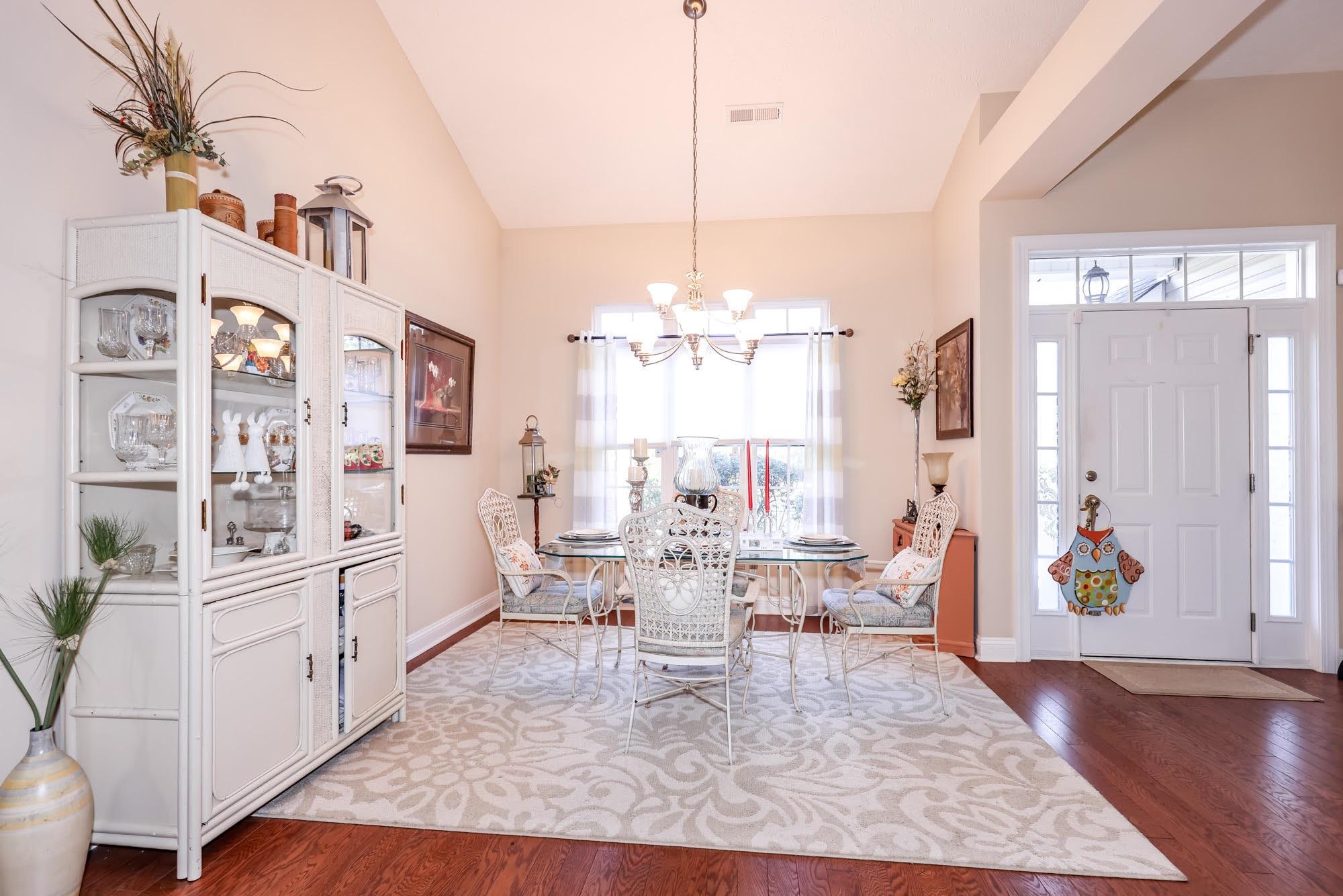147 Quail Hollow Road Myrtle Beach, SC 29579 - Photo 6 of 35 Dining space with a chandelier, lofted ceiling, and dark wood-type flooring