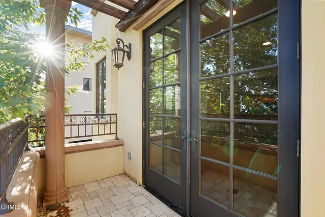 a kitchen with granite countertop stainless steel appliances white cabinets and a large window