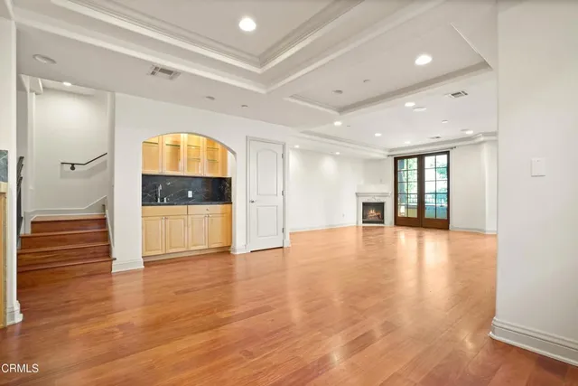a view of hallway with wooden floor and cabinet