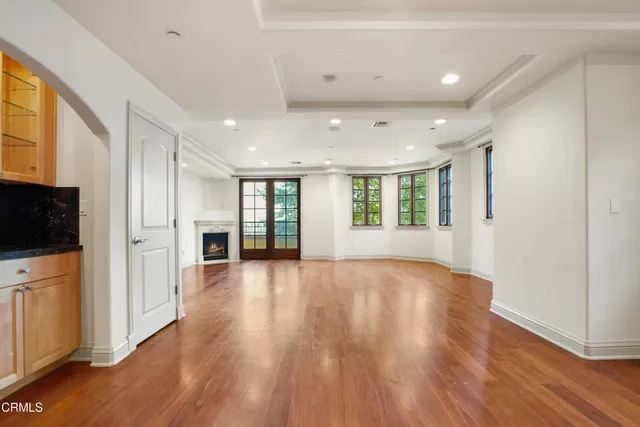 a view of an entryway with wooden floor and mirror