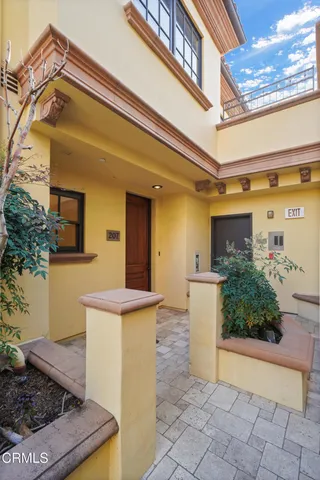 a view of an empty room with wooden floor and windows