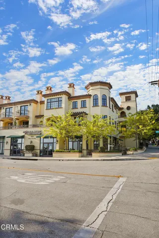 a view of a hallway with wooden floor and stairs