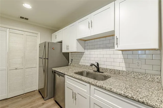 a kitchen with a sink and refrigerator