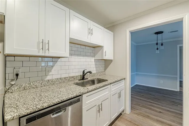 a kitchen with a sink and cabinets