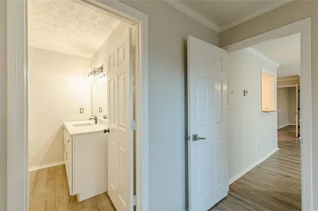 a view of a hallway with wooden floor