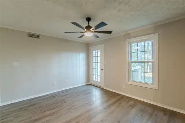 wooden floor in an empty room with a window