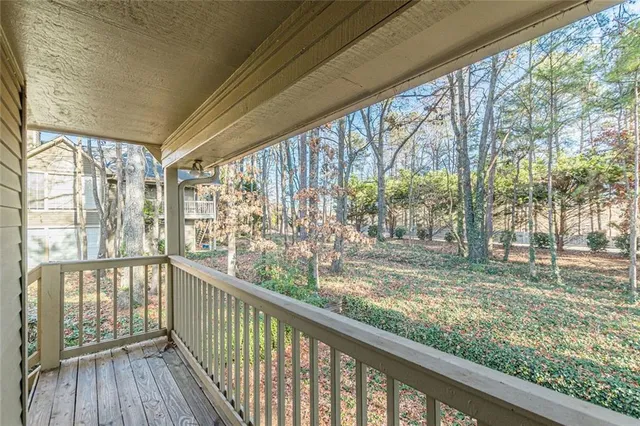 a view of a porch with wooden floor and outdoor space