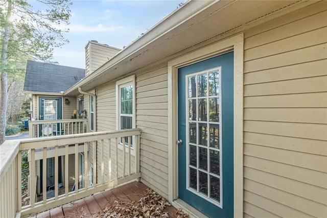 a view of house with a yard and potted plants