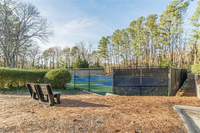 a wooden bench sitting in front of a house