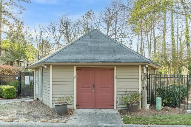 a view of a patio with table and chairs with wooden floor and fence