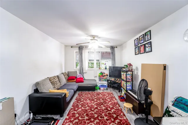 a view of a kitchen with fridge and wooden floor