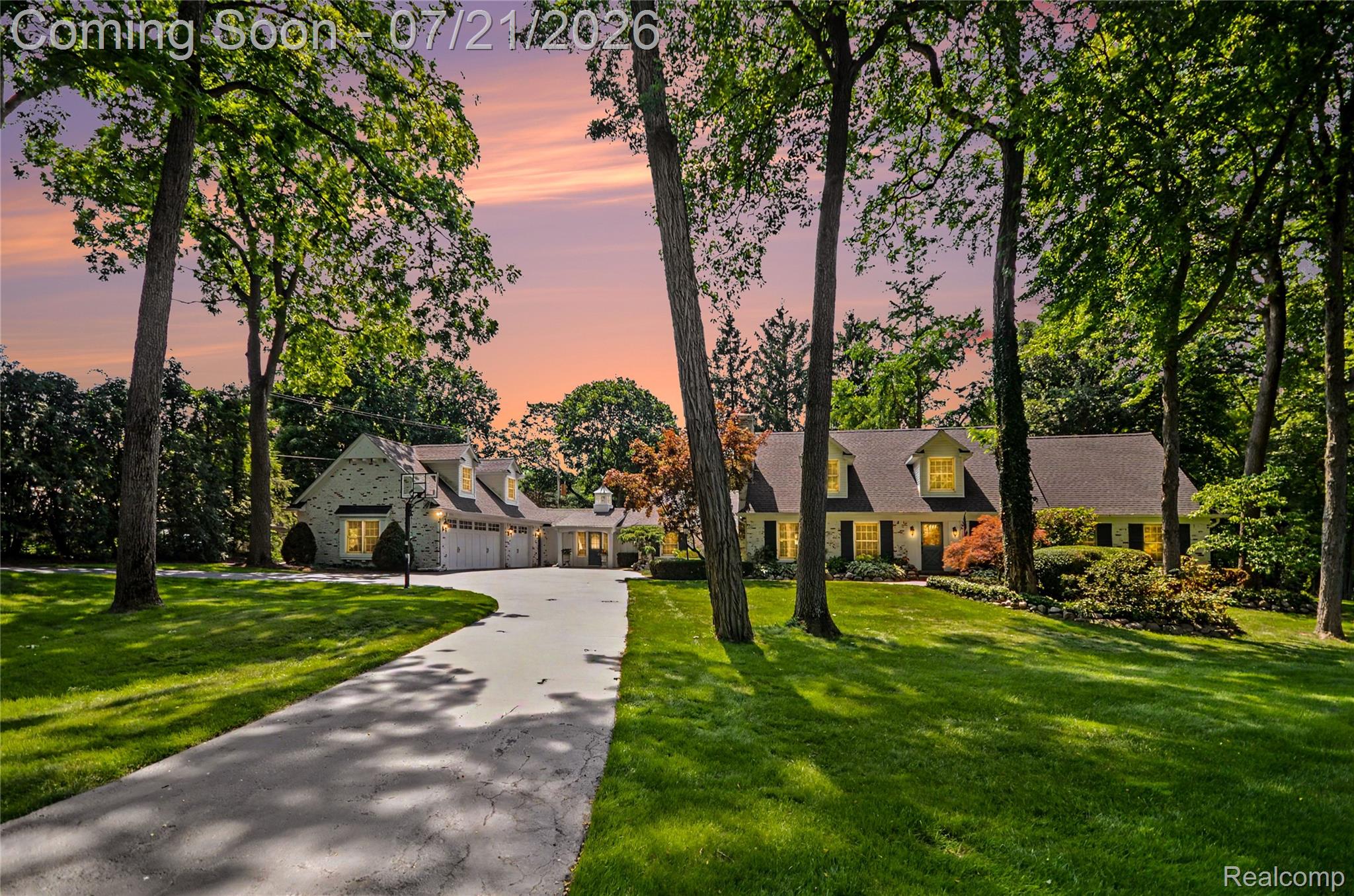 3780 Squirrel Road Bloomfield Hills, MI 48304 - Photo 1 of 59 Expansive property featuring a long driveway, a separate garage structure, mature trees, a manicured lawn, and exterior lighting