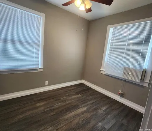 a view of a room with wooden floor and a window