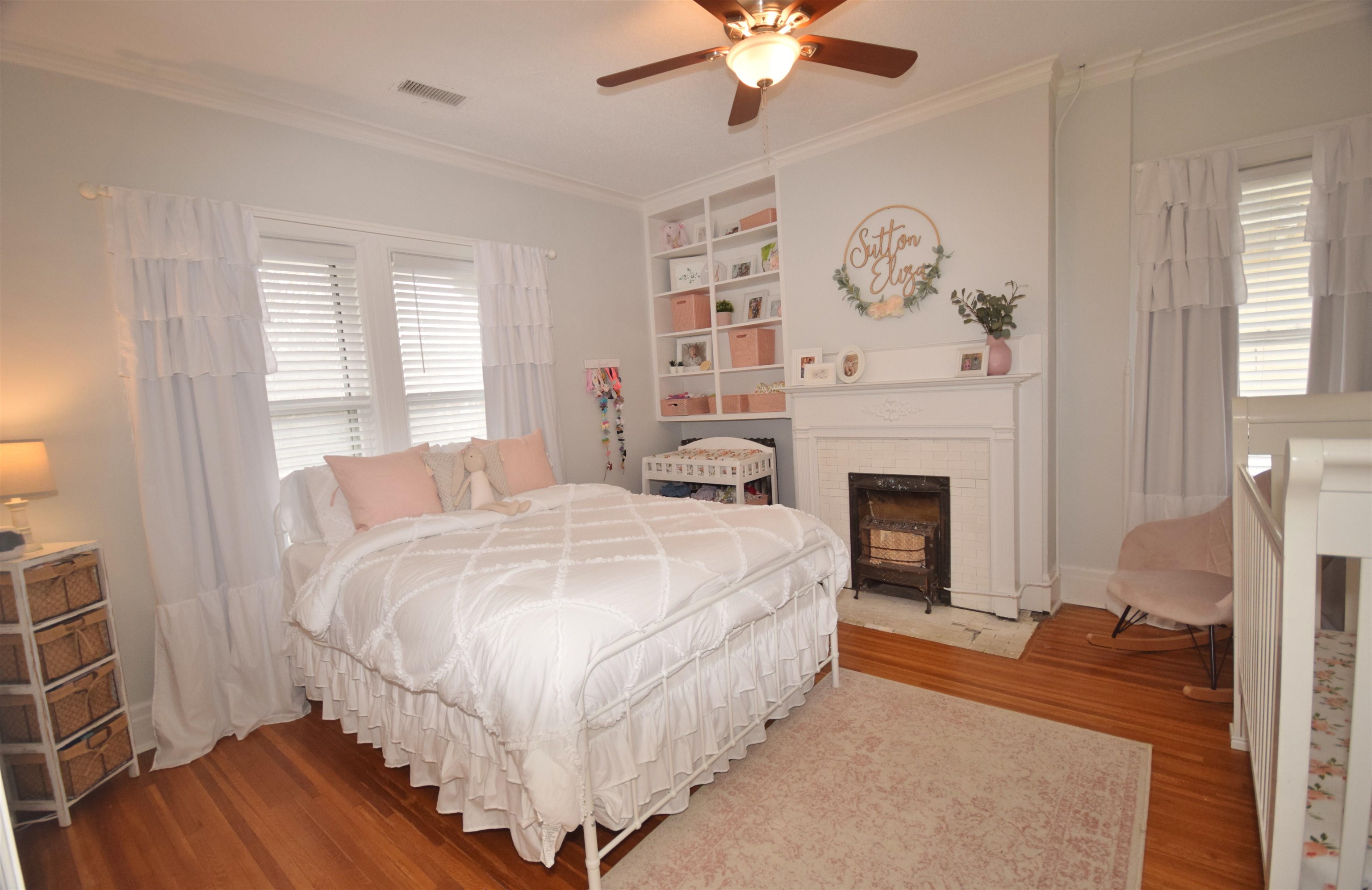263 Stonewall Street Memphis, TN 38112 - Photo 16 of 25 a spacious bedroom with a bed and a fireplace