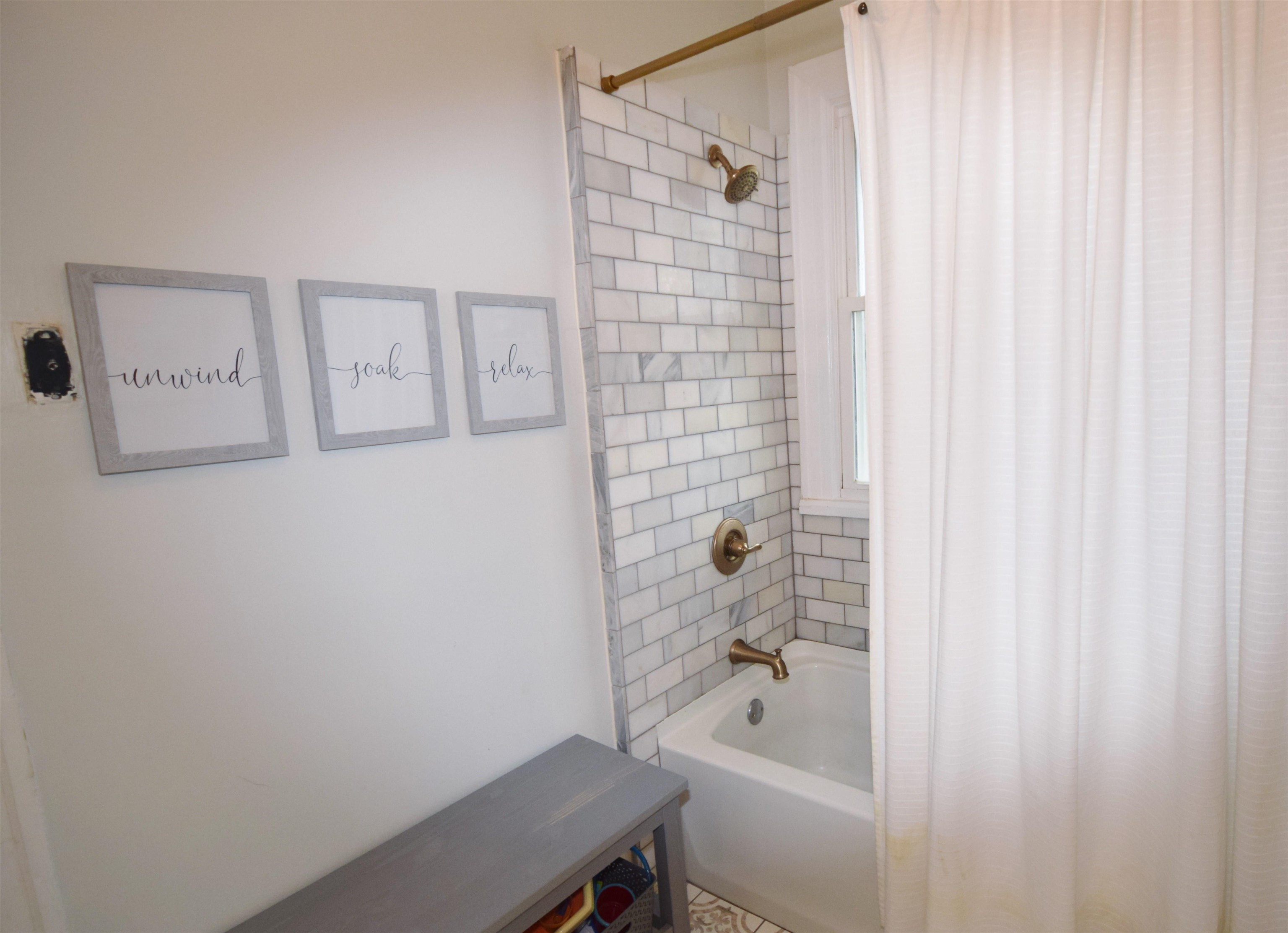 263 Stonewall Street Memphis, TN 38112 - Photo 21 of 25 a bathroom with a bathtub and shower