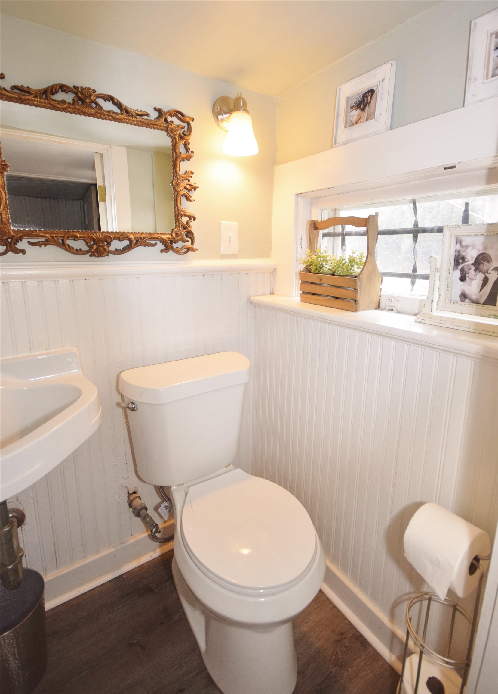 263 Stonewall Street Memphis, TN 38112 - Photo 23 of 25 a white toilet sitting next to a bathroom sink and vanity