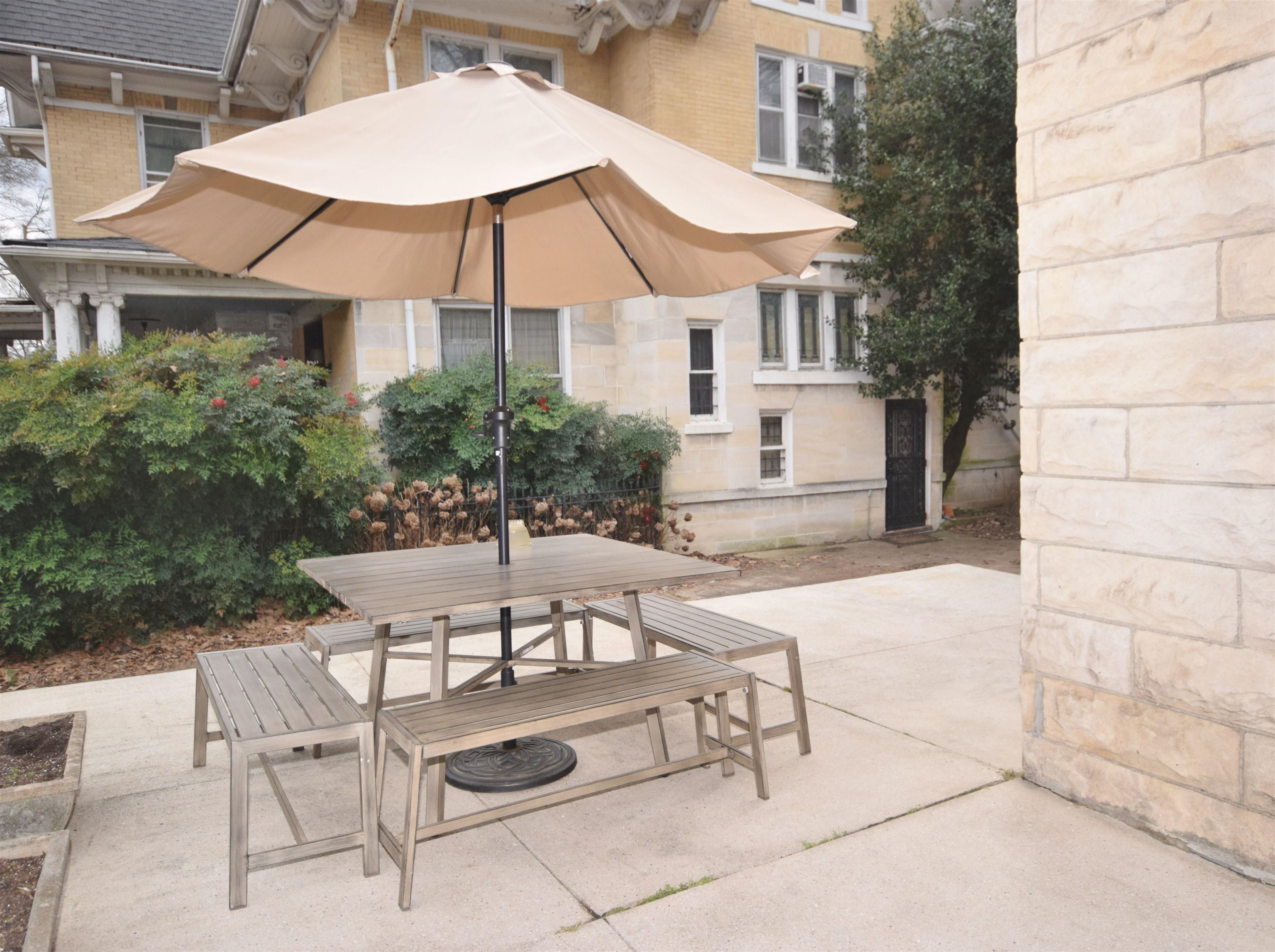 263 Stonewall Street Memphis, TN 38112 - Photo 24 of 25 a patio with a table and chairs under an umbrella