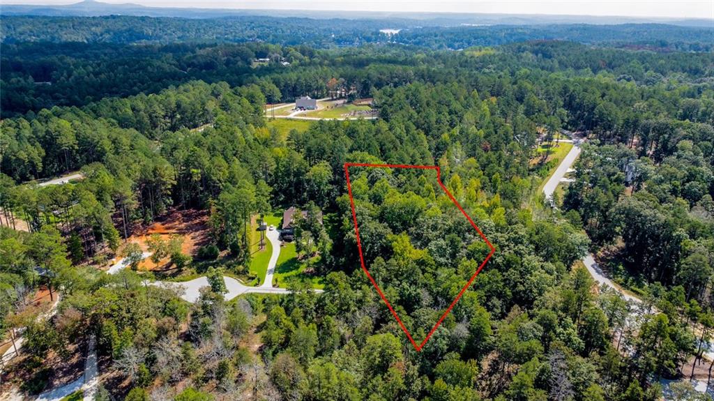 Lot 30 Harbor Point Seneca, SC 29672 - Photo 8 of 12 Discover a tranquil, wooded haven perfect for building your dream home, with clear mountain views and a nearby lake visible.