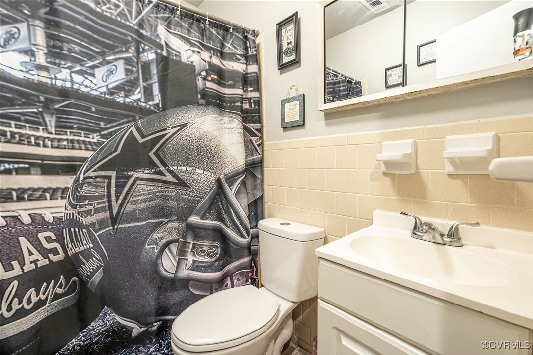 5316 Germain Road Richmond, VA 23224 - Photo 14 of 20 Bathroom featuring vanity, tile walls, and toilet