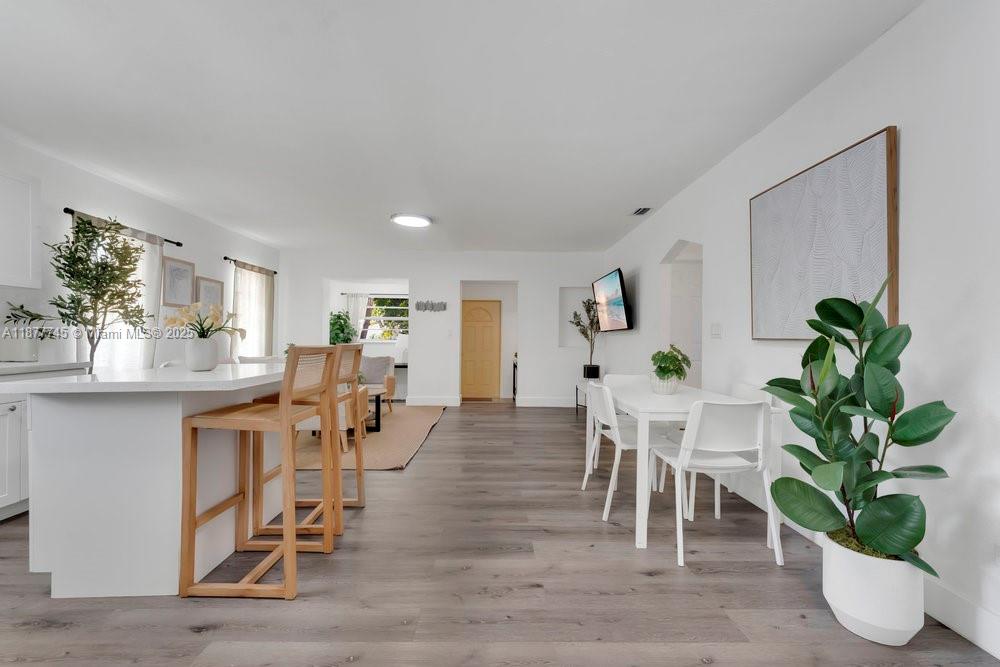 180 Northwest 69th Street Miami, FL 33150 - Photo 13 of 31 a view of a dining room with furniture and a potted plant