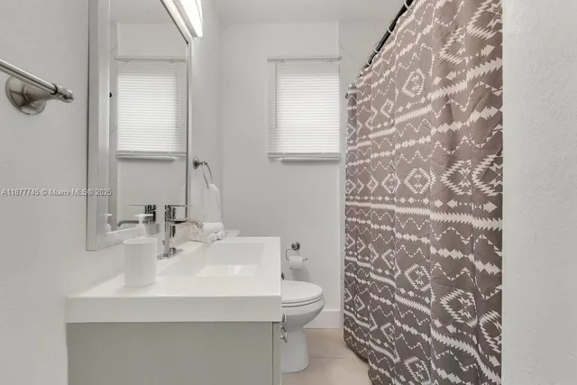 a bathroom with a sink toilet and mirror