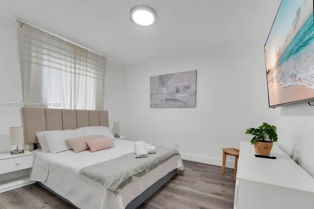 a room with a bed and a potted plant