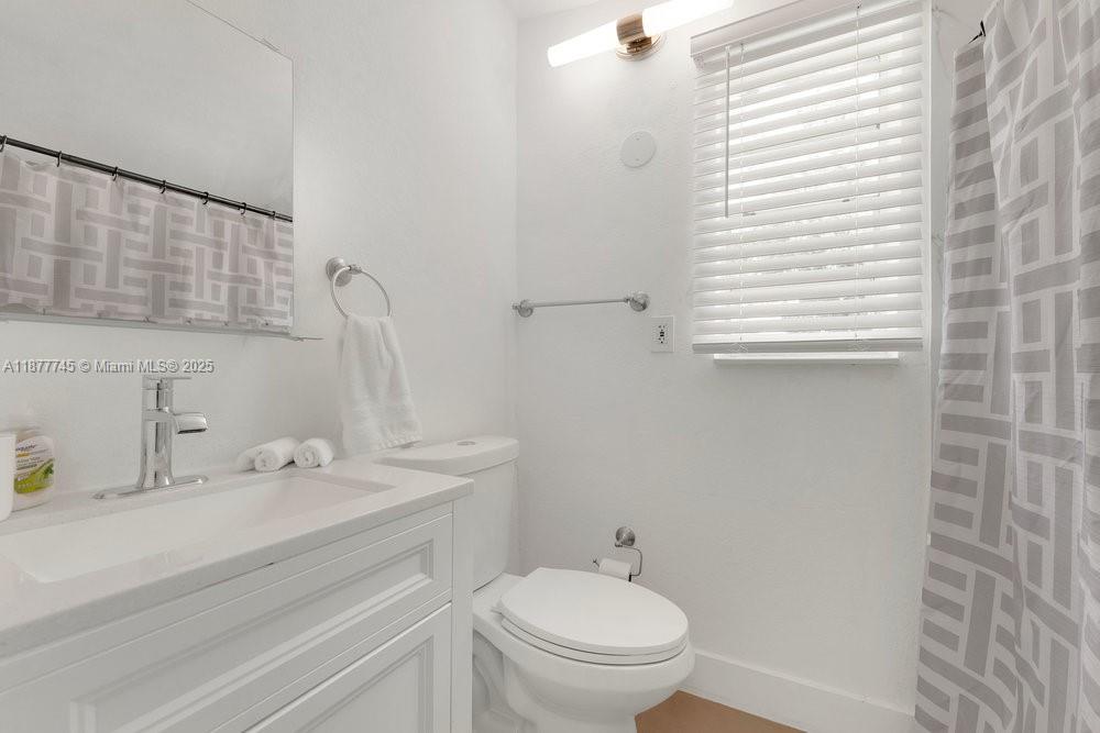 180 Northwest 69th Street Miami, FL 33150 - Photo 17 of 31 a bathroom with a sink and a toilet