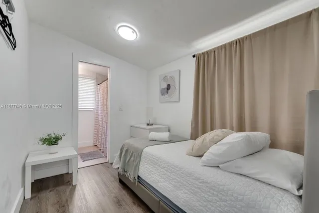 a bedroom with a bed and a potted plant