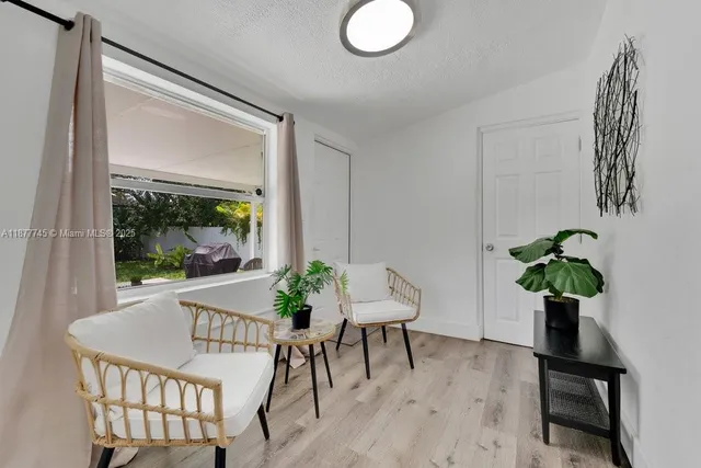 a view of a livingroom with furniture and a potted plant