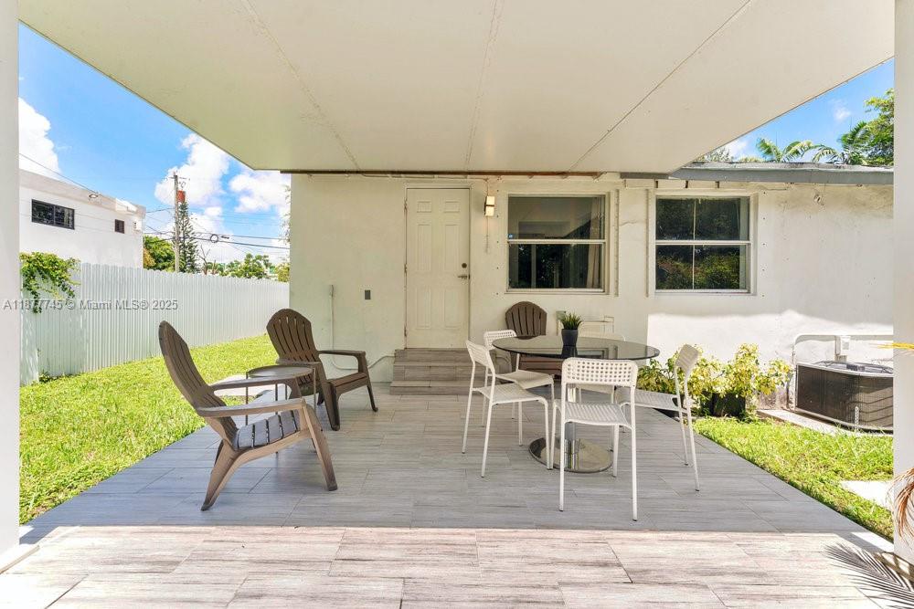 180 Northwest 69th Street Miami, FL 33150 - Photo 21 of 31 a dining room with furniture and wooden floor
