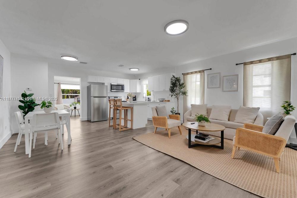 180 Northwest 69th Street Miami, FL 33150 - Photo 3 of 31 a living room with furniture and a wooden floor