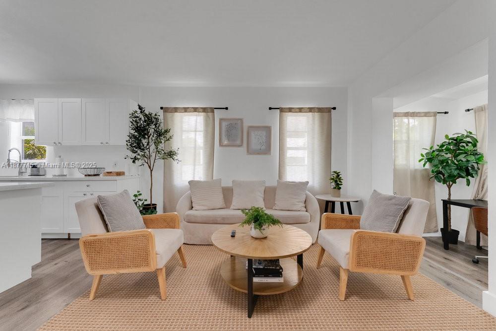 180 Northwest 69th Street Miami, FL 33150 - Photo 4 of 31 a living room with furniture and a potted plant