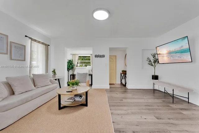 a living room with furniture and wooden floor