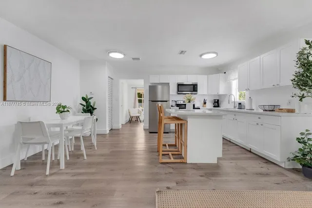 a kitchen with white cabinets and counter space