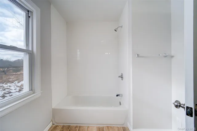 a white bath tub sitting next to a window