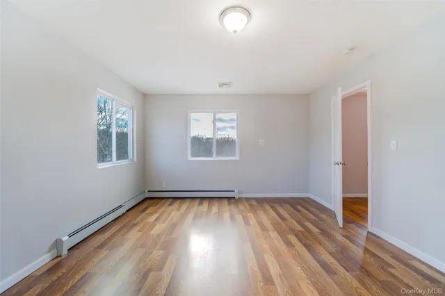 wooden floor in an empty room with a window
