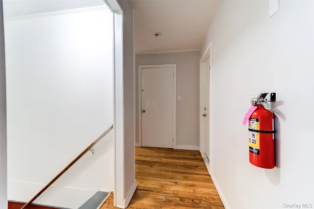 a view of a hallway with wooden floor and entryway