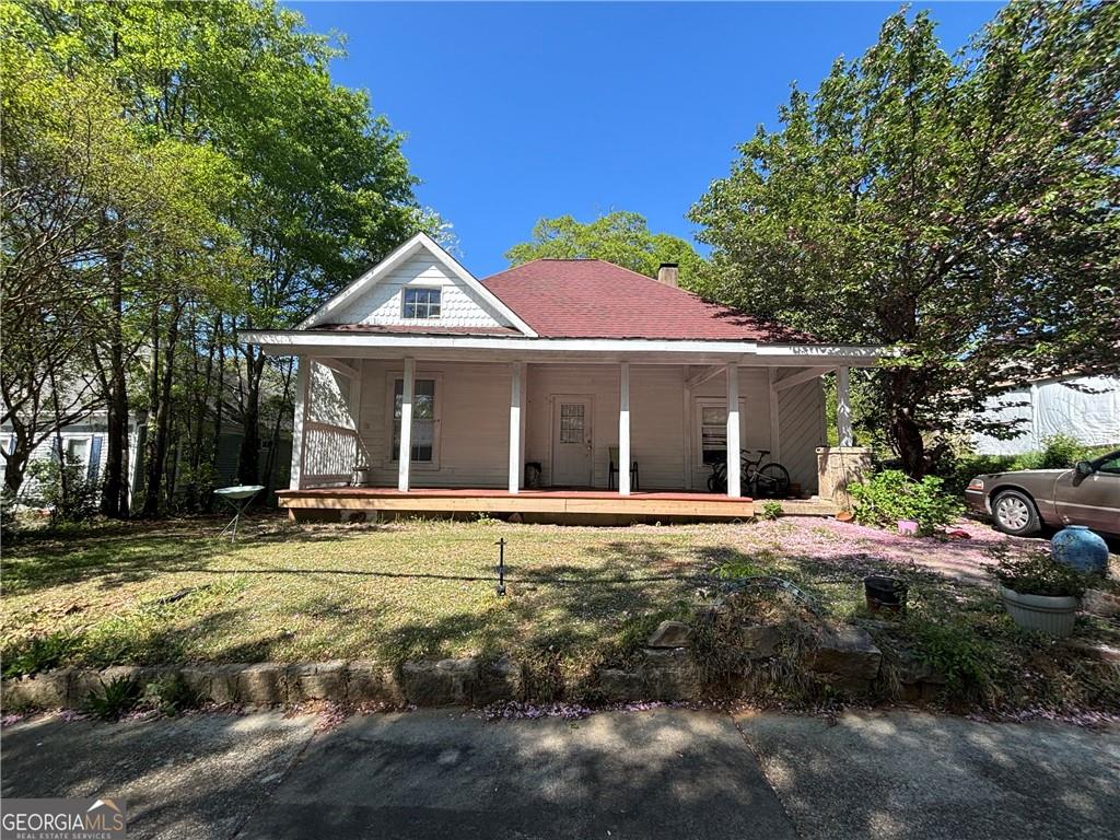 1090 Forrest Avenue Stone Mountain, GA 30083 - Photo 2 of 2 a front view of a house with a garden