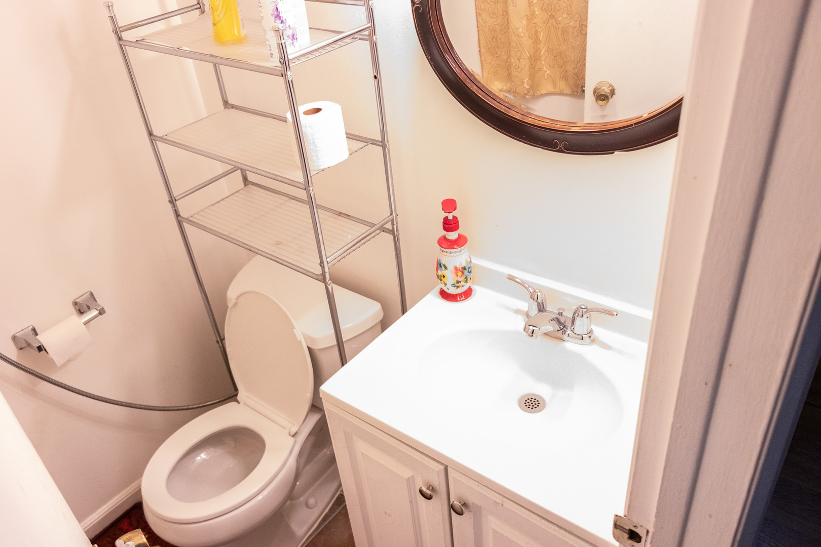 1488 Willow Avenue Des Plaines, IL 60016 - Photo 17 of 25 a bathroom with a sink a toilet and a mirror