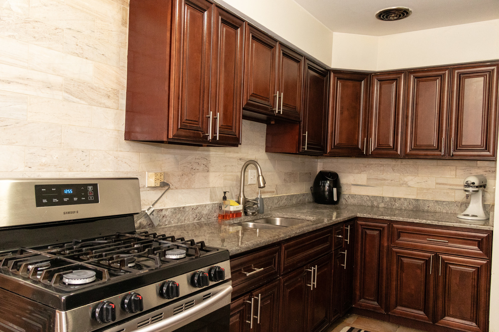1488 Willow Avenue Des Plaines, IL 60016 - Photo 6 of 25 a kitchen with granite countertop a stove and a sink