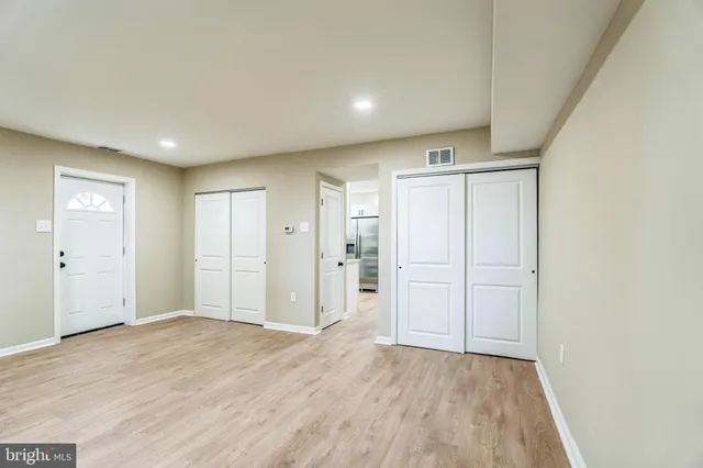 a view of empty room with wooden floor