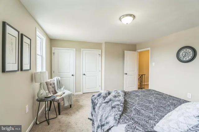 a bedroom with a bed and chair