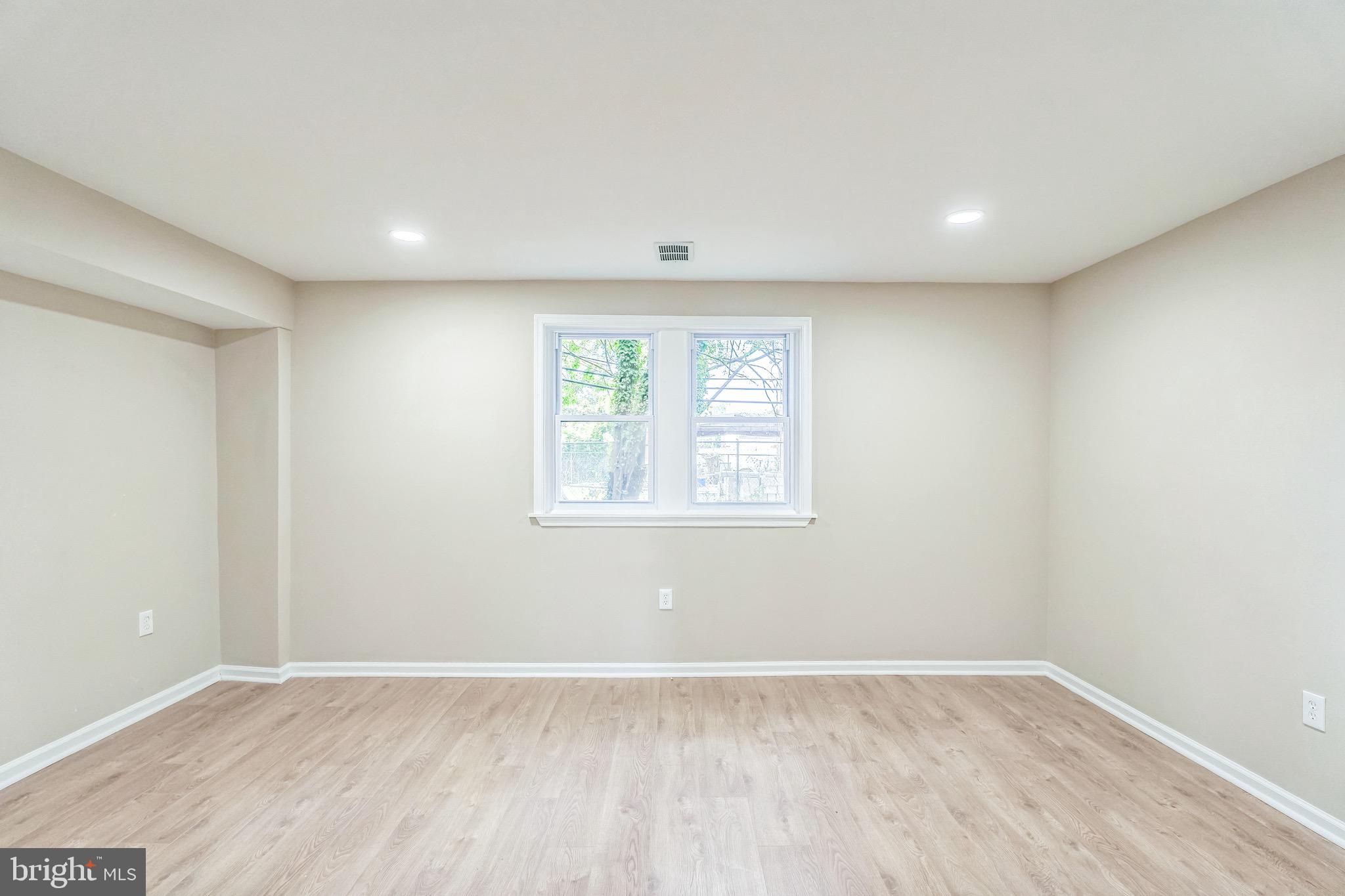 5734 Harbison Avenue Philadelphia, PA 19135 - Photo 21 of 29 an empty room with wooden floor and windows