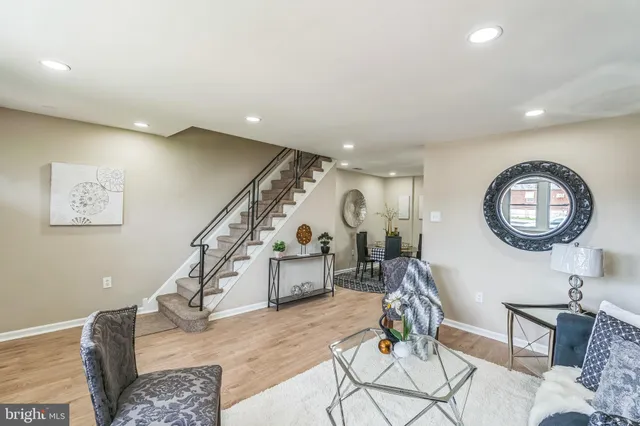 a living room with furniture and a clock