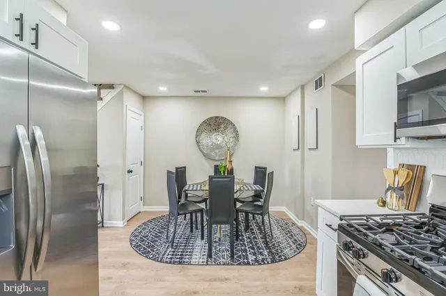 a kitchen with a table and a stove top oven