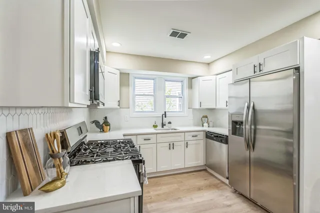 a kitchen with a refrigerator and a sink