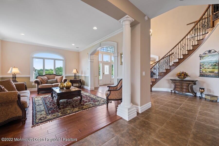 72 Edgewood Road Morganville, NJ 07751 - Photo 19 of 86 a living room with furniture and a dining table with rug floor
