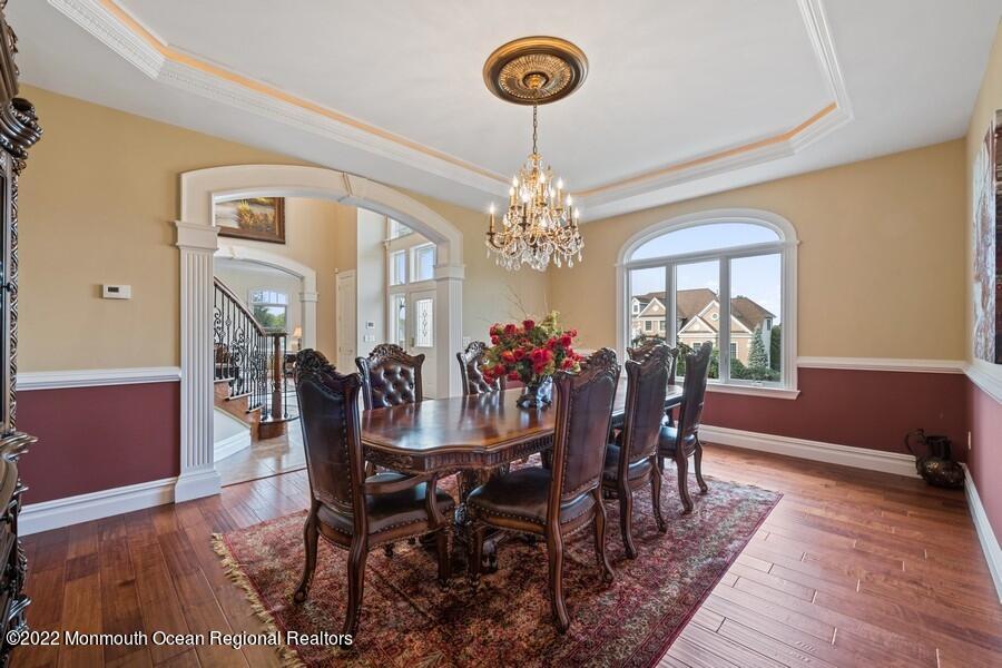 72 Edgewood Road Morganville, NJ 07751 - Photo 21 of 86 a view of a dining room with furniture a chandelier and wooden floor