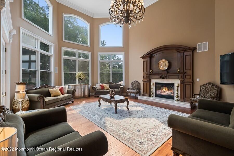 72 Edgewood Road Morganville, NJ 07751 - Photo 25 of 86 a living room with furniture a large window and a fireplace