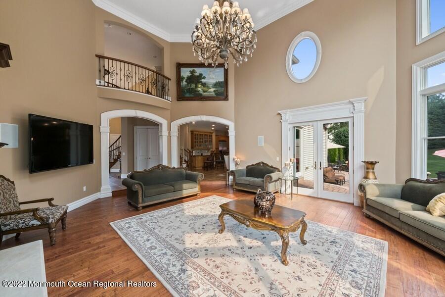 72 Edgewood Road Morganville, NJ 07751 - Photo 26 of 86 a living room with furniture a flat screen tv and a table